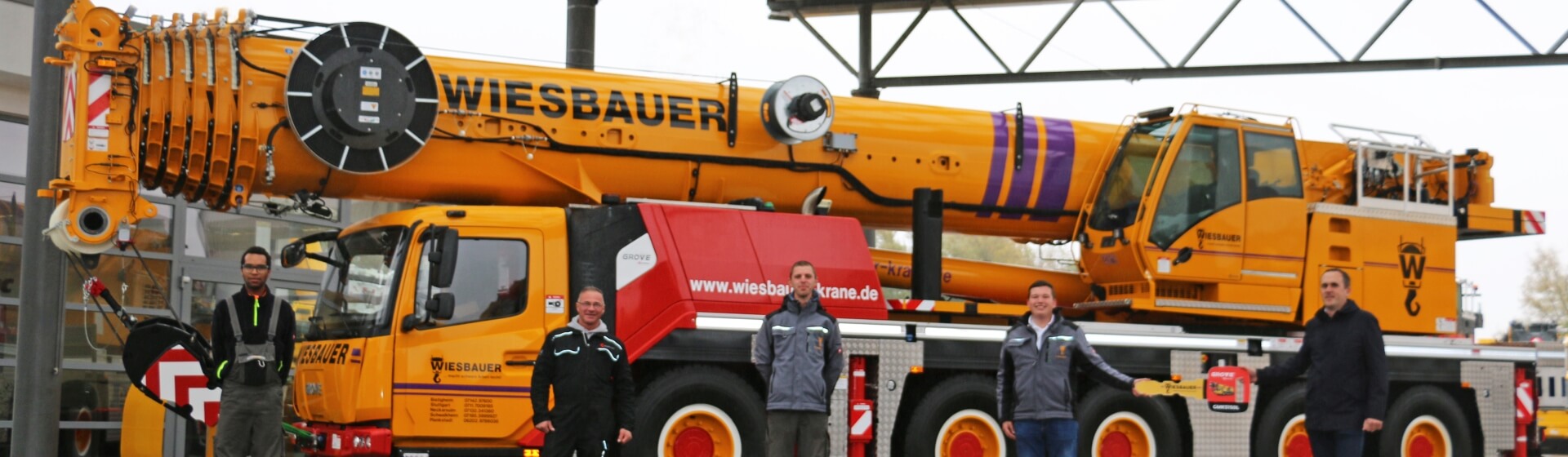 (from right) Lukas Brämer, sales representative for KranAgentur Werner; Felix Wiesbauer and the Wiesbauer crane operators Ralf Hoffman, Samuele Polidori and Jannik Weigle celebrate the handover of the new GMK5150L. Wiesbauer-strengthens-fleet-with-new-Grove-GMK5150L-all-terrain-crane-1.jpg