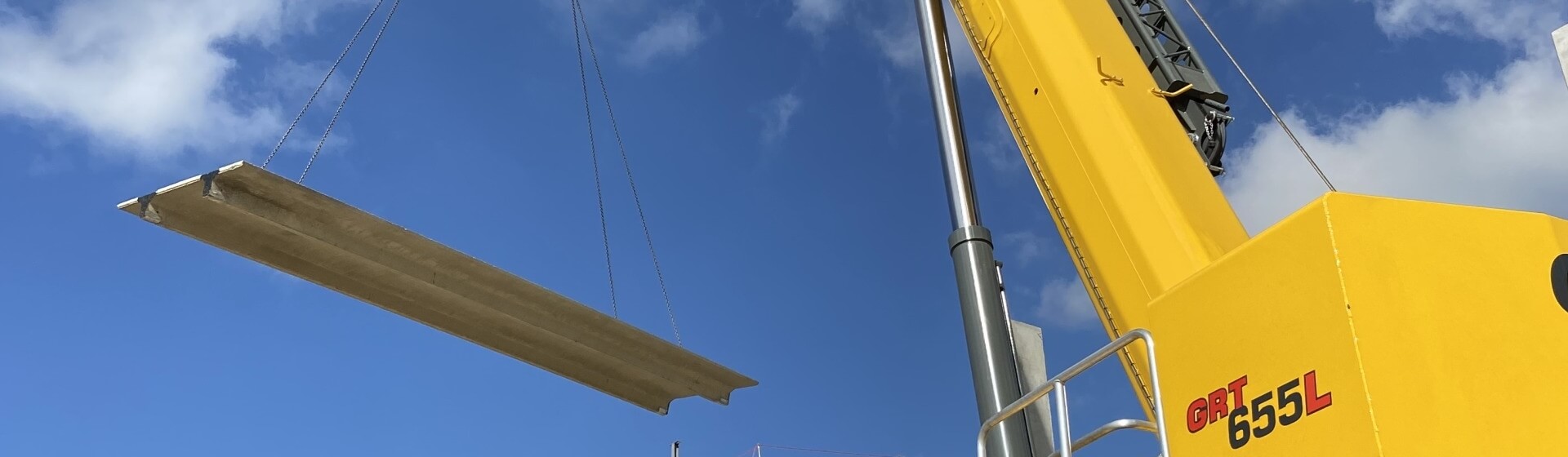 A Grove GRT655L rough-terrain crane at work installing a precast concrete structure. Five-key-points-to-know-about-the-Grove-GRT655-GRT655L-rough-terrain-crane-1.jpg
