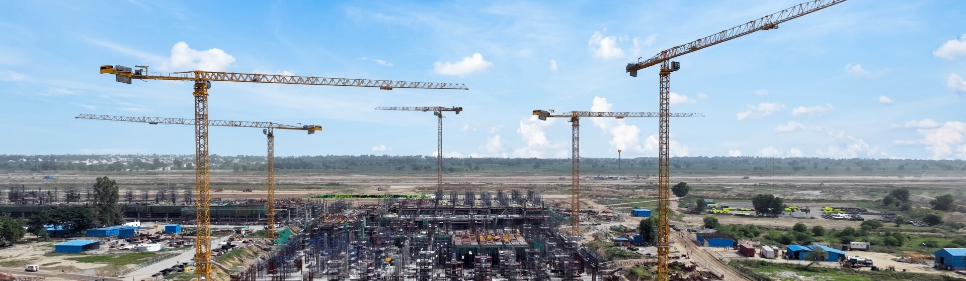 Construction company Tata Projects is using five Potain cranes to build Noida International Airport, which will eventually become the largest airport in India. Five-Potain-cranes-chosen-for-Indias-groundbreaking-new-airport-01.jpg