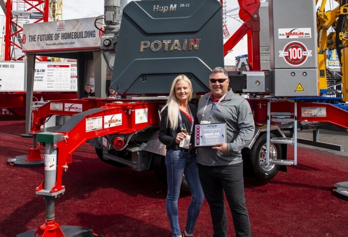 Dennis Davis, founder and owner of Davis Company, and Ashley Young celebrate the company’s new Potain Hup M 28-22 crane at CONEXPO 2020. Davis-Company-first-Hup-M-28-22-self-erecting-tower-crane-in-North-America-1.jpg