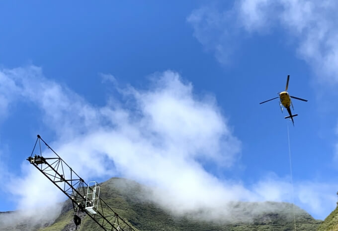 A helicopter lifts the components to assemble the Potain MCT 58. Potain-MCT-58-installed-by-helicopter-on-hydroelectric-dam-at-volcano-foot-02.jpg