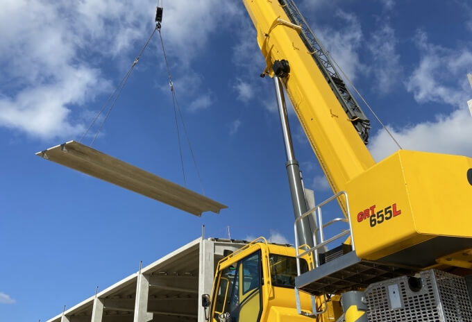 A Grove GRT655L rough-terrain crane at work installing a precast concrete structure. Five-key-points-to-know-about-the-Grove-GRT655-GRT655L-rough-terrain-crane-1.jpg