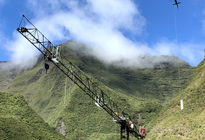 GLI used a helicopter to lift elements in the assembly of a Potain MCT 58 crane on a dam on La Réunion. Credit: GLI Potain-wins-big-at-2021-Tower-Crane-Awards-in-Paris-2.jpg