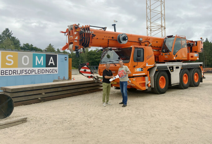 Erik Baas of Manitowoc (left) and Jeroen Boekelo of SOMA (right) celebrate the delivery of the Grove GMK3060-1. Netherlands-training-facility-chooses-Grove-GMK3060-1-for-new-operators-01.jpg